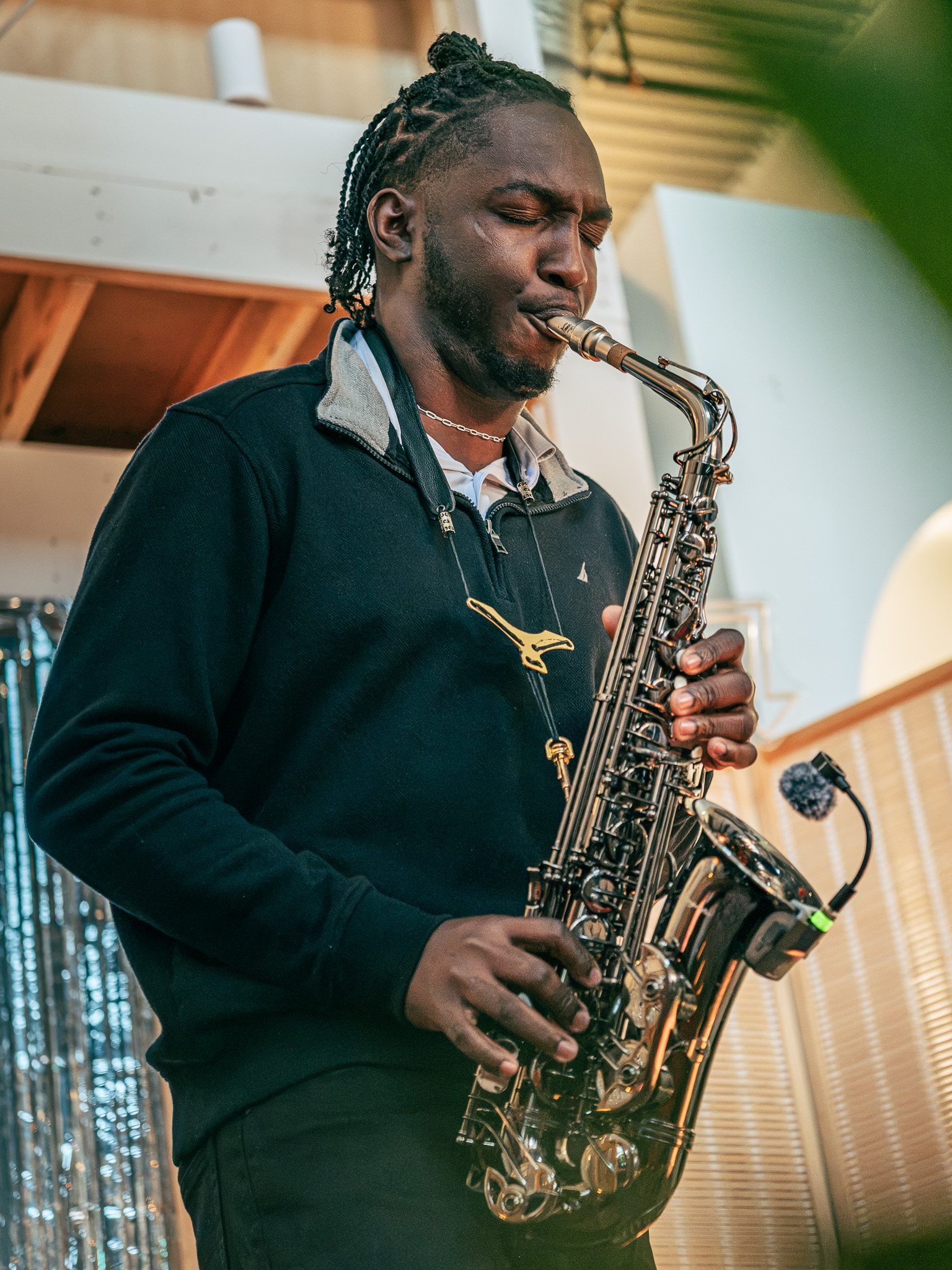 Jade Brooks playing saxophone during an evening event